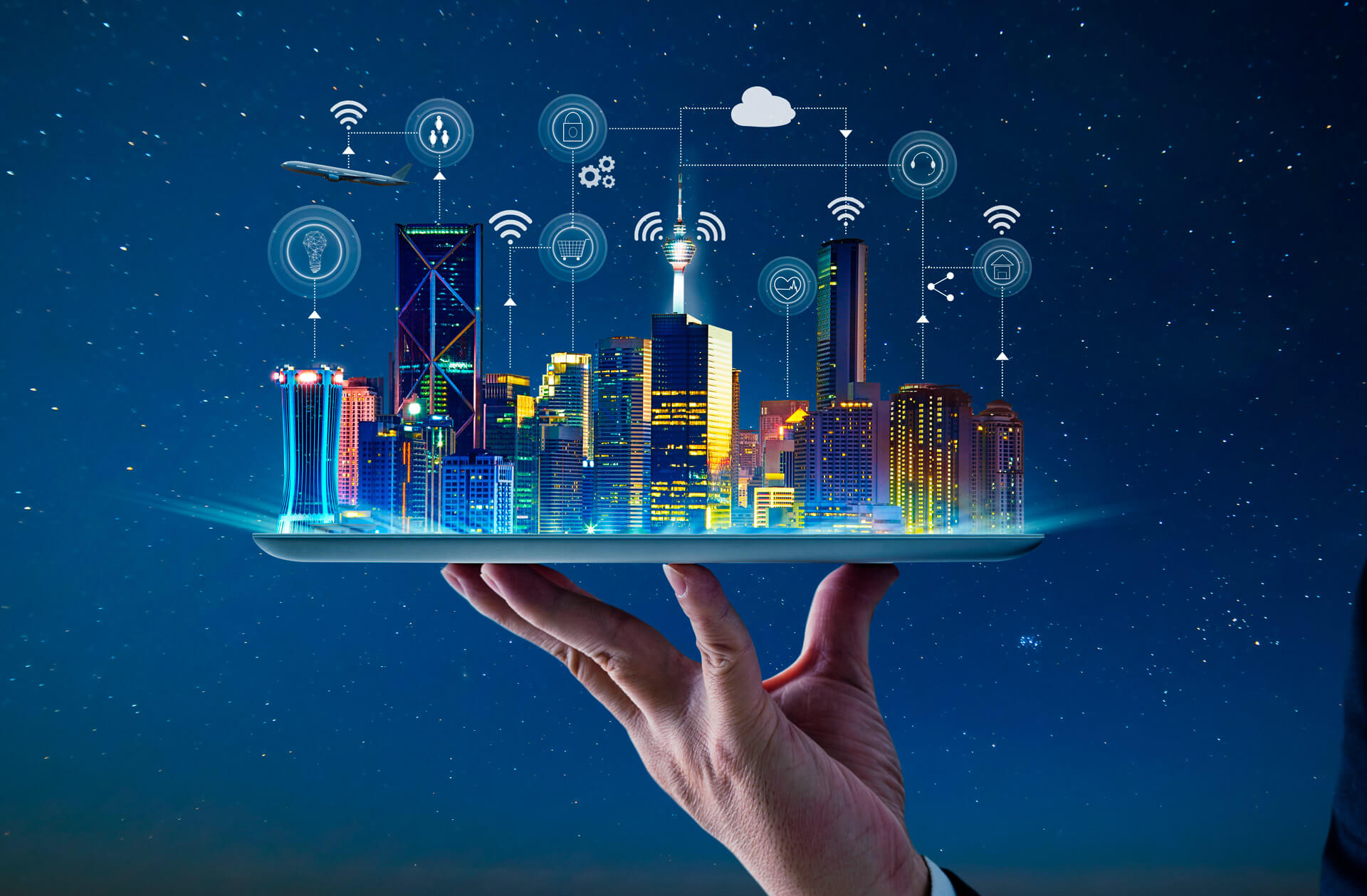 A connected city illustrated above a tablet held in one hand